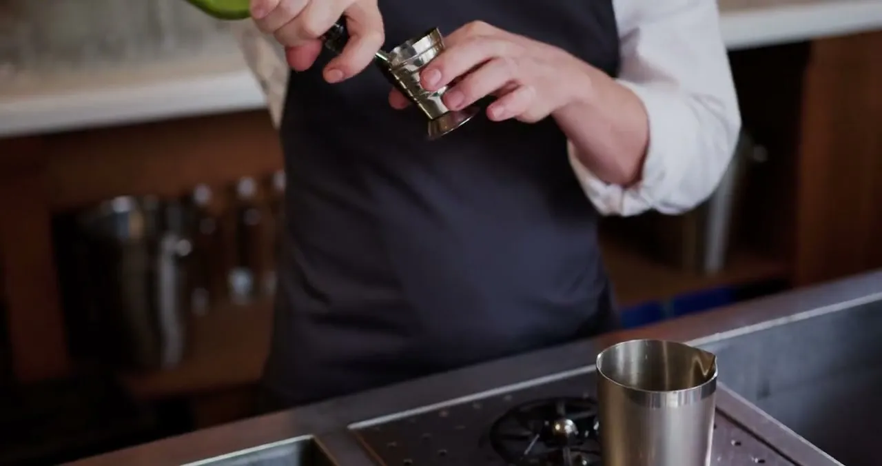 A bartender preparing a cocktail at a neighborhood bar