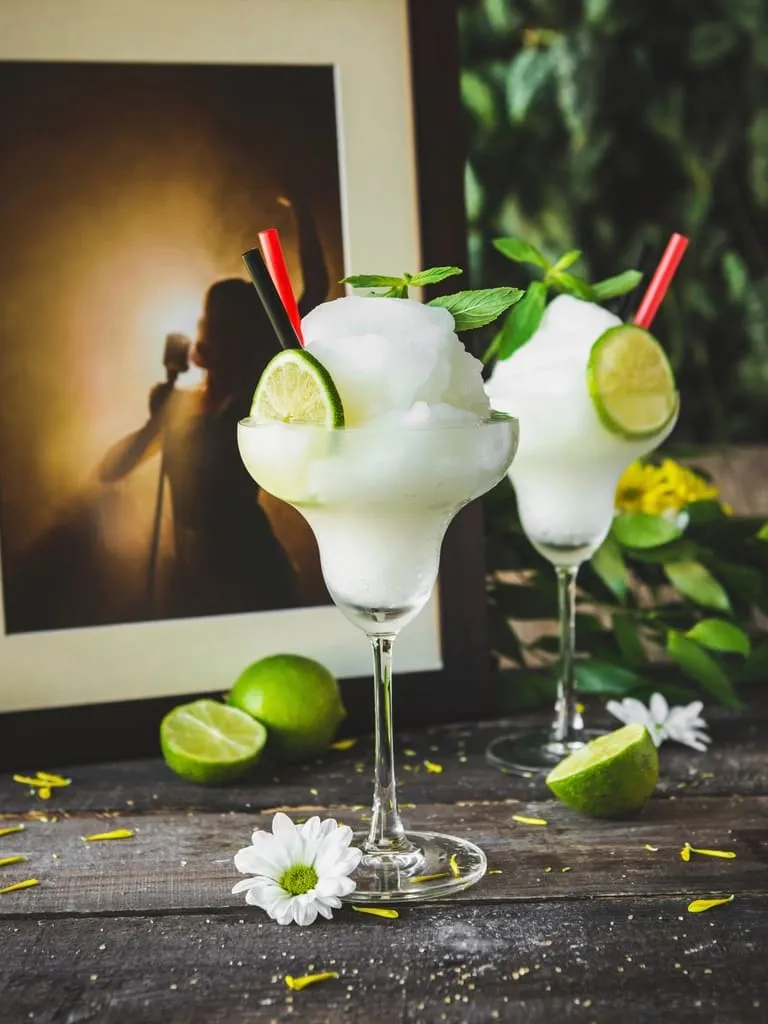 A cocktail served with a fresh citrus garnish